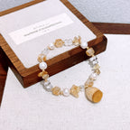 Handmade dried flower lucky charm bracelet with natural yellow crystal sunstone and freshwater pearl – a gentle and elegant accessory