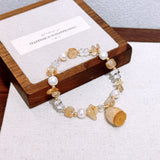 Handmade dried flower lucky charm bracelet with natural yellow crystal sunstone and freshwater pearl – a gentle and elegant accessory